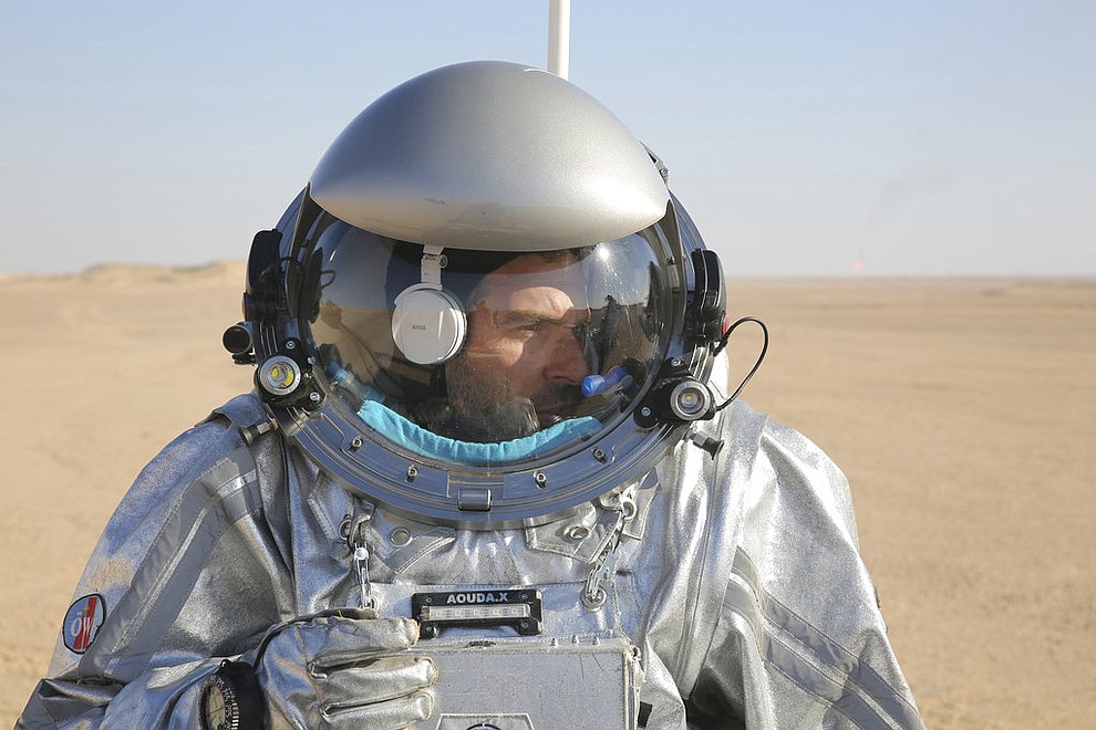 This Feb. 7, 2018, photo shows JoÃ£o Lousada, a flight controller for the International Space Station, wearing an experimental space suit during a simulation of a future Mars mission in the Dhofar desert of southern Oman. The desolate desert in southern Oman resembles Mars so much that more than 200 scientists from 25 nations organized by the Austrian Space Forum are using it for the next four weeks to field-test technology for a manned mission to Mars. (AP Photo/Sam McNeil)