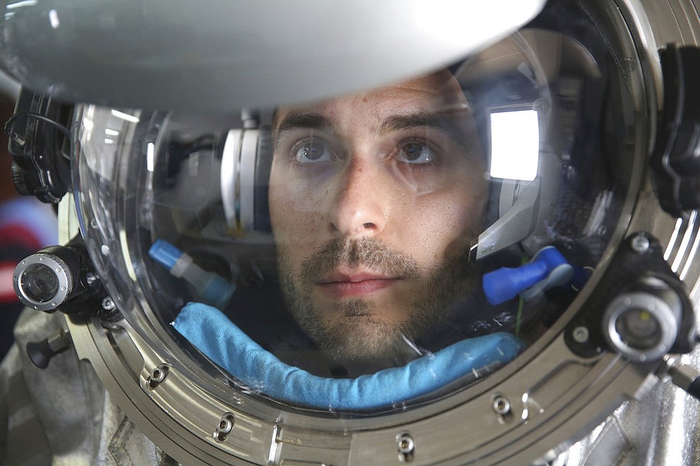 This Feb. 7, 2018, photo shows JoÃ£o Lousada, a flight controller for the International Space Station, wearing an experimental space suit during a simulation of a future Mars mission in the Dhofar desert of southern Oman. The desolate desert in southern Oman resembles Mars so much that more than 200 scientists from 25 nations organized by the Austrian Space Forum are using it for the next four weeks to field-test technology for a manned mission to Mars. (AP Photo/Sam McNeil)