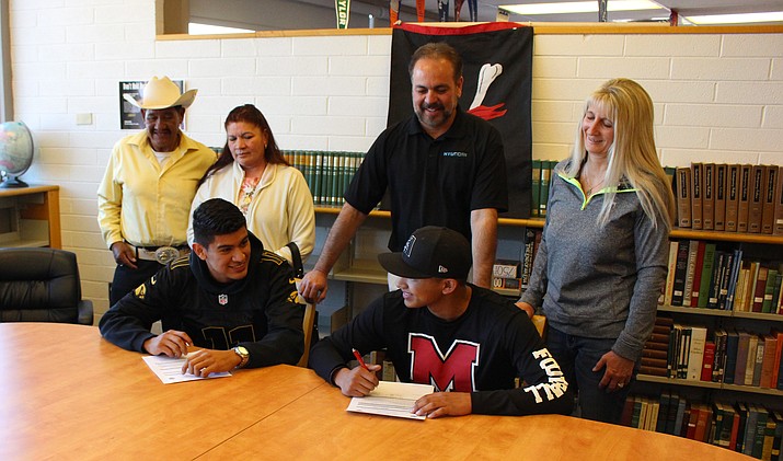 Mingus seniors Martin Soria (left) and Marcos Valenzuela (right) sign with Phoenix College football on Wednesday at the MUHS library. (VVN/James Kelley)