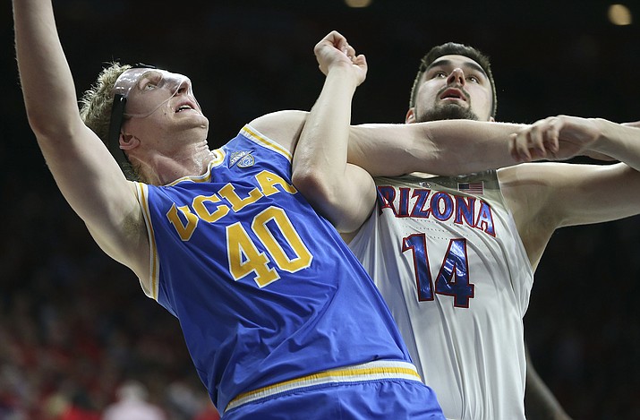 UCLA center Thomas Welsh (40) and Arizona's Dusan Ristic (14) wait for a rebound during the second half Thursday, Feb. 8, 2018, in Tucson. UCLA defeated Arizona 82-74. (Ralph Freso/AP)