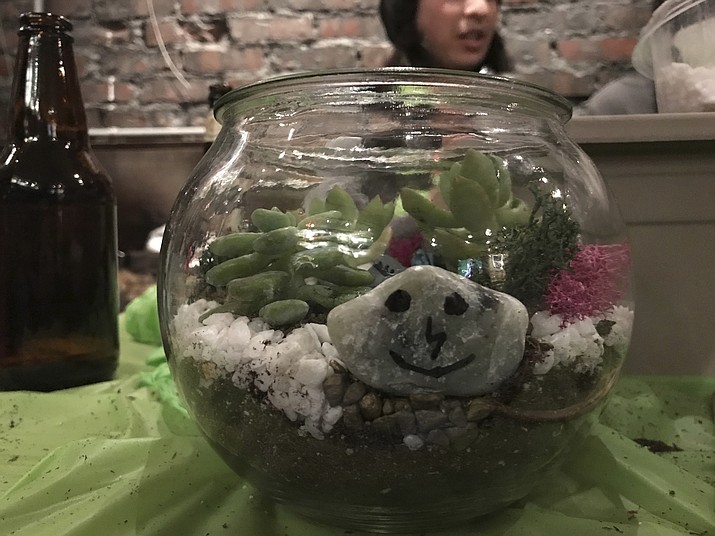 This Nov. 18, 2017 photo provided by Tracee Herbaugh shows a terrarium created at Plant Nite at a bar in downtown Boston. (Tracee Herbaugh via AP)