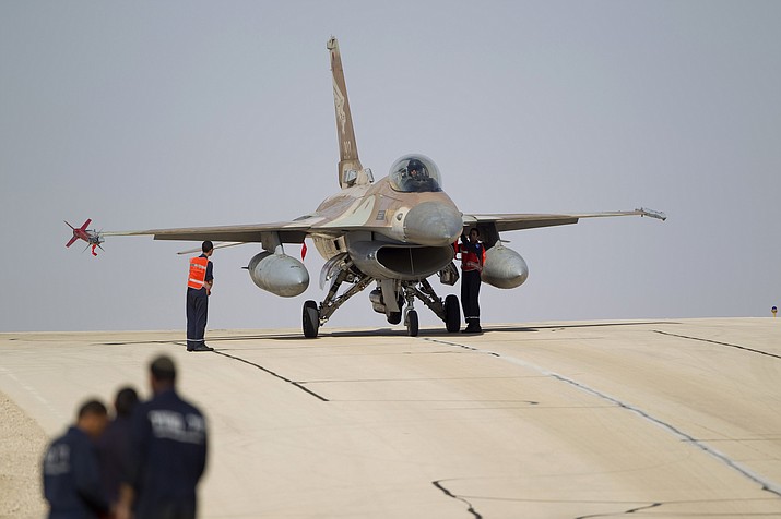 In this Monday, Nov 25, 2013, file photo, technicians inspect an Israeli air force F-16 jet at the Ovda airbase near Eilat, southern Israel. The Israeli military says it has shot down an Iranian drone that infiltrated the country and has struck Iranian targets in Syria that launched it. The military says that as part of the unusual event one of its F-16 jets crashed in northern Israel. (AP Photo/Ariel Schalit, File)

