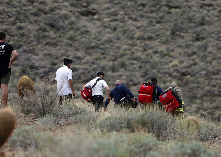 In this Saturday, Feb. 10, 2018, photo, emergency personnel arrive at the scene of a deadly tour helicopter crash along the jagged rocks of the Grand Canyon, in Arizona. (Teddy Fujimoto via AP)

