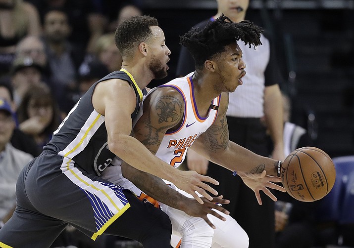 Phoenix Suns’ Elfrid Payton, right, is defended by Golden State Warriors’ Stephen Curry during the first half Monday, Feb. 12, 2018, in Oakland, Calif. (Marcio Jose Sanchez/AP)
