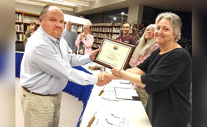 Danny Howe, administrator-in-charge at Camp Verde Unified School District, recognizes outgoing board member Christine Schneider at the board’s Tuesday, Feb. 13 meeting. Schneider had been on the school district’s governing board for the past five years. (Photo by Bill Helm)