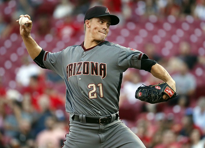In this July 19, 2017, file photo, Arizona Diamondbacks starting pitcher Zack Greinke throws in the second inning against the Cincinnati Reds in Cincinnati. After an All-Star season but scuffling in the playoffs, Greinke is back for his third season with the Diamondbacks. (John Minchillo/AP, File)