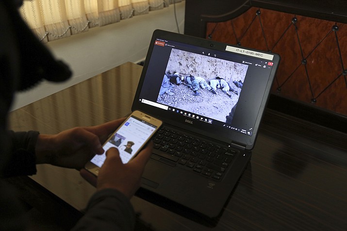 In this Friday, Feb. 9, 2018 photo, Shoaib, whose father and 13 others were killed in Afghanistan’s central Ghor Province by gunmen in 2014, seen on screen, gives an interview to The Associated Press in Kabul, Afghanistan. Since the International Criminal Court began collecting material three months ago for a possible war crimes case involving Afghanistan, it has collected a staggering 1.17 million statements from Afghans who say they were victims. Abdul Wadood Pedram, of the Kabul-based Human Rights and Eradication of Violence Organization said, the statements not only include accounts of alleged atrocities by groups like the Taliban and the Islamic State, but also by Afghan Security Forces and government-affiliated warlords, the U.S.-led coalition, and foreign and domestic spy agencies. (AP Photo/Rahmat Gul)

