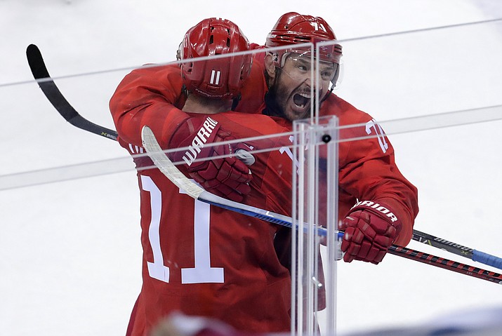 Russian athlete Ilya Kovalchuk (71) celebrates with Sergei Andronov (11) after scoring a goal during the second period of the preliminary round of the men's hockey game at the 2018 Winter Olympics in Gangneung, South Korea, Saturday, Feb. 17, 2018. (Julio Cortez/AP)