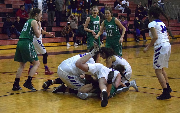 Camp Verde and Thatcher battle for a loose ball at the end of regulation during the Cowboys’ 48-47 overtime loss to the Eagles during the first round of the state tournament at Bradshaw Mountain.  (VVN/James Kelley)