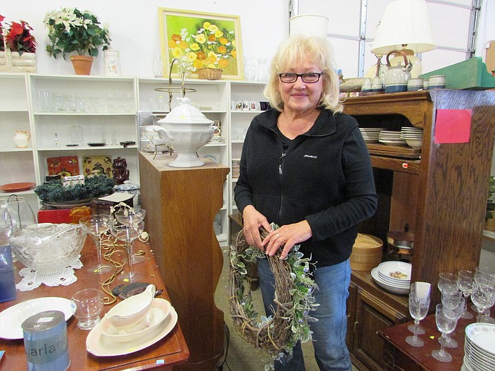 Kitty Shankwitz standing among the many different items that NOAH Thrift Store offers to the community in Prescott.