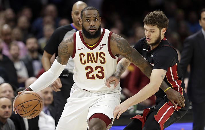 Cleveland Cavaliers’ LeBron James, left, in this Wednesday, Jan. 31, 2018 file photo, drives past Miami Heat’s Tyler Johnson in the second half of an NBA basketball game in Cleveland. LeBron James says he will not stick to sports. The Cleveland Cavaliers superstar reiterated his determination to speak out on social issues and the nation’s political climate Saturday, Feb. 17, 2018 during his media availability for the NBA All-Star Game. (Tony Dejak/AP, File)