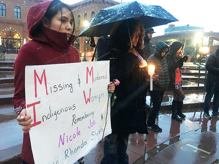 Nicole Joe's mother, Rosemary Begay, (right) holds a candle at a vigil held Feb. 14 in Flagstaff. The vigil also called attention to other Native women who are missing or who have been murdered. (Katherine Locke/NHO)