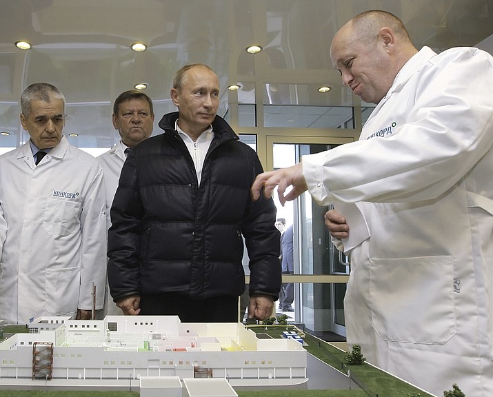 In this Monday, Sept. 20, 2010 file photo, businessman Yevgeny Prigozhin, right, shows Russian President Vladimir Putin, second right, around his factory which produces school means, outside St. Petersburg, Russia. On Friday Feb. 16, 2018, Yevgeny Prigozhin along with 12 other Russians and three Russian organizations, were charged by the U.S. government as part of a vast and wide-ranging effort to sway political opinion during the 2016 U.S. presidential election.(Alexei Druzhinin, Sputnik, Kremlin Pool Photo via AP, File)

