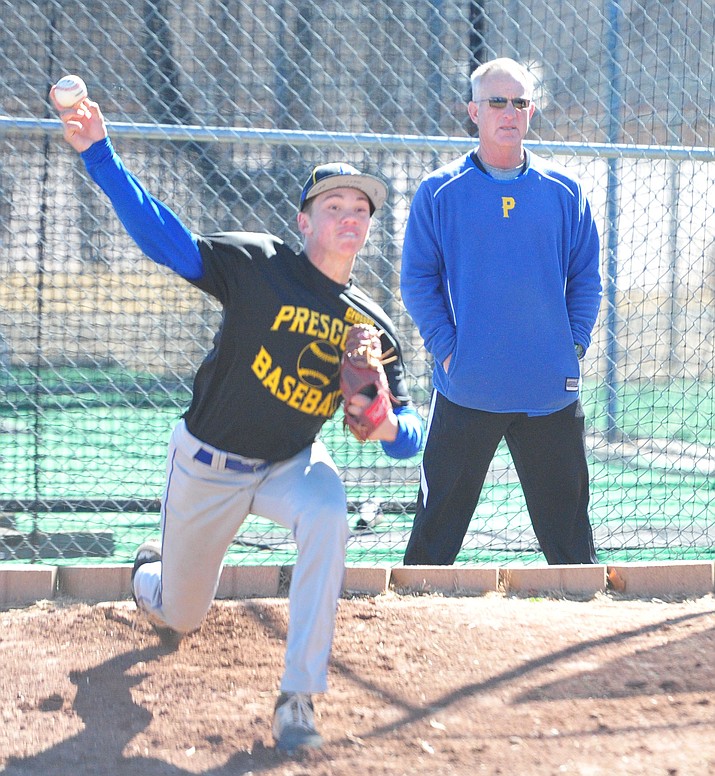 Prescott starting pitcher Jake Schulz warms up before practice Tuesday, Feb. 20, 2018, as head coach Kent Winslow looks on. Schulz is expected to be the No. 1 starter on the mound for the Badgers in 2018.