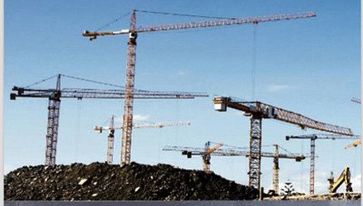 This screen shot from a report released on the website of New York state’s economic development agency, Empire State Development, shows seven towering heavy-lift cranes to help illustrate the state’s growth, but the Associated Press has discovered the picture is really an 8-year-old photo of construction cranes in South Africa. An un-cropped version of the same photo is available for licensing on the Getty Images website with a caption saying the cranes were being used to build a stadium in Cape Town for the 2010 soccer World Cup. Empire State Development said Tuesday Feb. 20, 2018 that the photo is “a generic stock image” and will replaced with an image of ongoing economic development in the state. (Empire State Development via AP)

