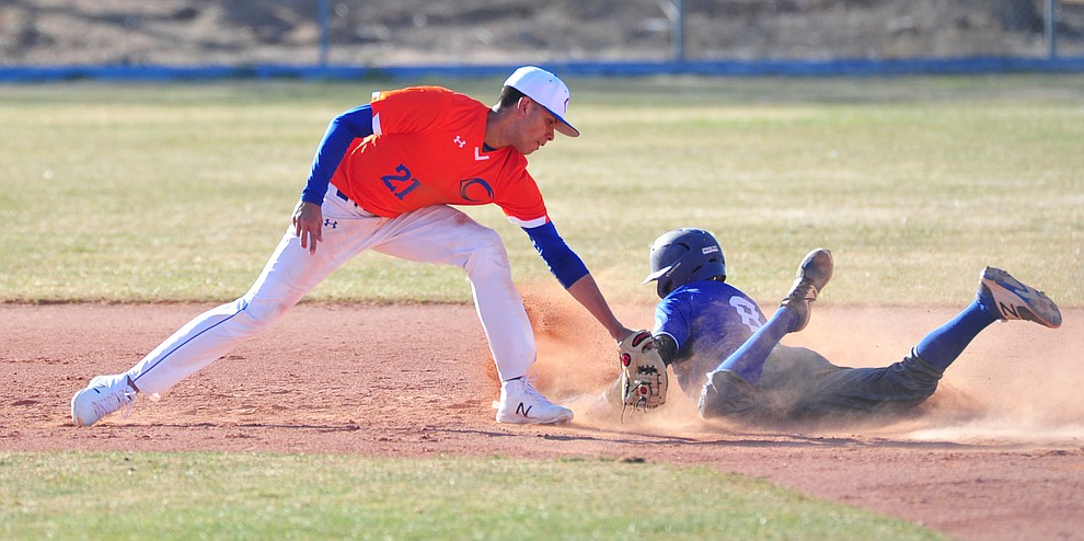 Chino Valley's Abdiel Sanchez tries to tag out a Lobo runner as the Cougars play the Snowflake Lobos to open the 2018 baseball season Thursday afternoon in Chino Valley. (Les Stukenberg/Courier)