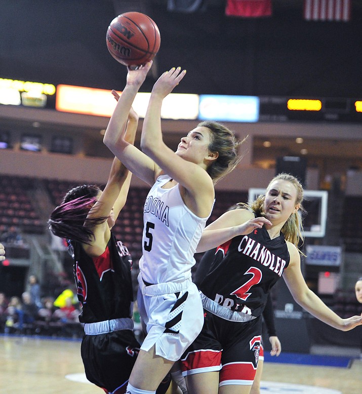 Sedona Red Rock’s Liza Westervelt (5) gets a hard shot off as the Scorpions play in the Arizona Interscholastic Association Division 2 semifinal against the Chandler Prep Titans Friday, Feb. 23, 2018, at the Prescott Valley Event Center. (Les Stukenberg/Courier)