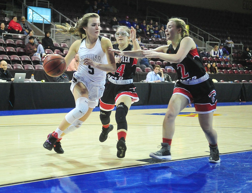 Sedona Red Rock's Liza Westervelt (5) drives past a pair of defenders as the Scorpions play in the Arizona Interscholastic Association Division 2 semifinal against the Chandler Prep Titans Friday  at the Prescott Valley event Center. (Les Stukenberg/Courier)