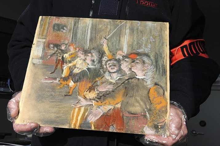 This photo taken Thursday Feb. 22, 2018 and provided by French Customs shows a stolen painting by French painter Edgar Degas. French customs have discovered an original Impressionist masterpiece by Edgar Degas stolen in 2009 _ in a suitcase on a bus. (Marc Bonodot/French Customs via AP)
