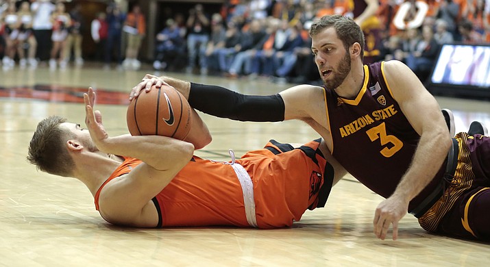 Oregon State’s Tres Tinkle, left, fights for the ball with Arizona State’s Mickey Mitchell (3) in the first half Saturday, Feb. 24, 2018, in Corvallis, Ore. (Timothy J. Gonzalez/AP)