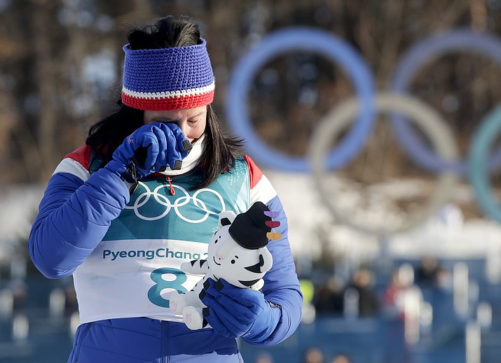 Marit Bjoergen, of Norway, wipes a tear away after winning the gold medal in the women’s 30k cross-country skiing competition at the 2018 Winter Olympics in Pyeongchang, South Korea, on Sunday, Feb. 25, 2018. (Dmitri Lovetsky/AP)