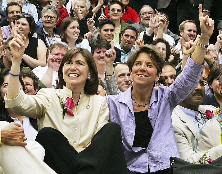 In this 2005 file photo, Julie, front left, and Hillary Goodridge pose with other gay couples and supporters as they celebrate their first wedding anniversary in Boston. The couple, who led the legal fight for Massachusetts to become the first state to legalize same-sex marriages, filed for divorce Thursday, Jan. 29, 2009. The U.S. Supreme Court on Monday refused to overturn a ruling that entitles gay couples who divorce to the same parenting rights as opposite-sex couples who divorce have. (AP Photo/Elise Amendola, File)