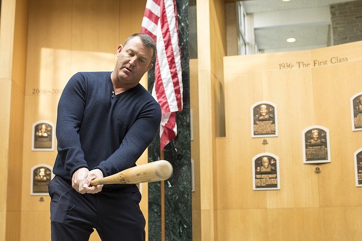 In this photo provided by the National Baseball Hall of Fame and Museum, former Cleveland Indians slugger Jim Thome demonstrates his swing  in the Plaque Gallery during his orientation tour of the National Baseball Hall of Fame and Museum, Tuesday, Feb. 27, 2018, in Cooperstown, N.Y., to prepare for his induction this summer. (Milo Stewart Jr./National Baseball Hall of Fame and Museum via AP)