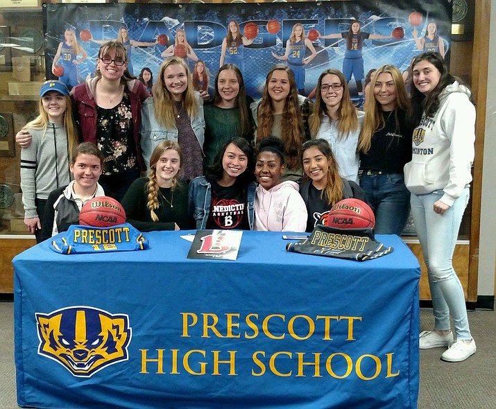 Surrounded by friends, Theresa Gutierez signs a letter of intent to play basketball for the University of Benedictine-Mesa on Feb. 22 in Prescott. (PHS Athletics/Courtesy)