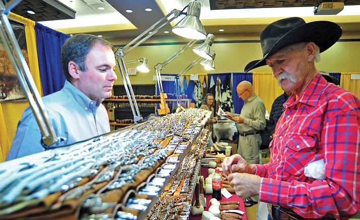 Terry Milliken of Wickenburg, chats with Barry King, owner of Barry King Tools, about his different leather stamps at the Prescott Resort.