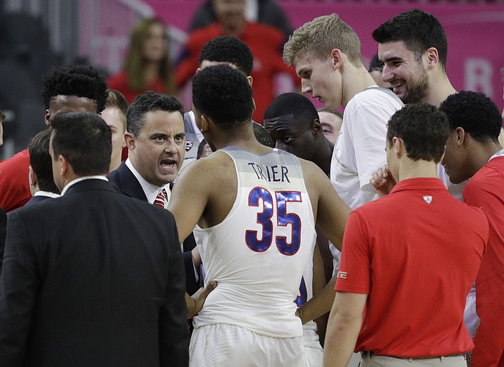 Arizona coach Sean Miller speaks with his players. After days of limbo, on Thursday the UA announced Miller would remain as coach of the Wildcats and he led them to a win that night against Stanford. (AP Photo/John Locher)