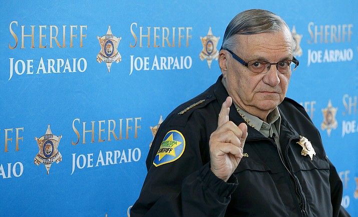 In this Dec. 18, 2013, file photo, Maricopa County Sheriff Joe Arpaio pauses as he answers a question during a news conference at Maricopa County Sheriff’s Office Headquarters in Phoenix. The family of a mentally ill man who alleges he died after being beaten and shot with a stun gun by law enforcement officers in one of the Phoenix-area jails run by Arpaio could receive $7 million in a lawsuit settlement. The lawsuit is one of many filed against Arpaio -- now a candidate for a U.S. Senate seat -- over the treatment of inmates in county jails during Arpaio's 24 years as metro Phoenix’s top law enforcer. (Ross D. Franklin/AP, File)