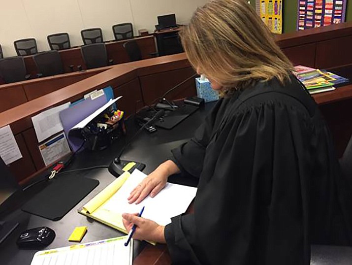 Yavapai County Superior Court Judge Anna Young looks over Foster Care Review Board reports before a dependency hearing in juvenile court Friday, March 2, 2018, in Prescott. (YCSC/Courtesy)