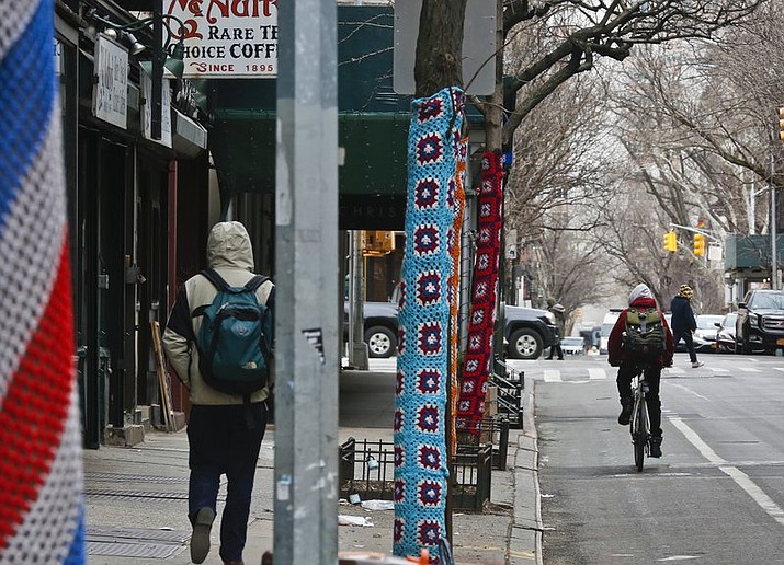 Trees along Christopher Street are shown decorated in crocheted patterns, Monday, March 5, 2018, in New York. The New York City Parks Department says a cluster of trees in the West Village neighborhood can keep their crocheted art after residents of the neighborhood said that it increased business and foot traffic. (AP Photo/Bebeto Matthews)


