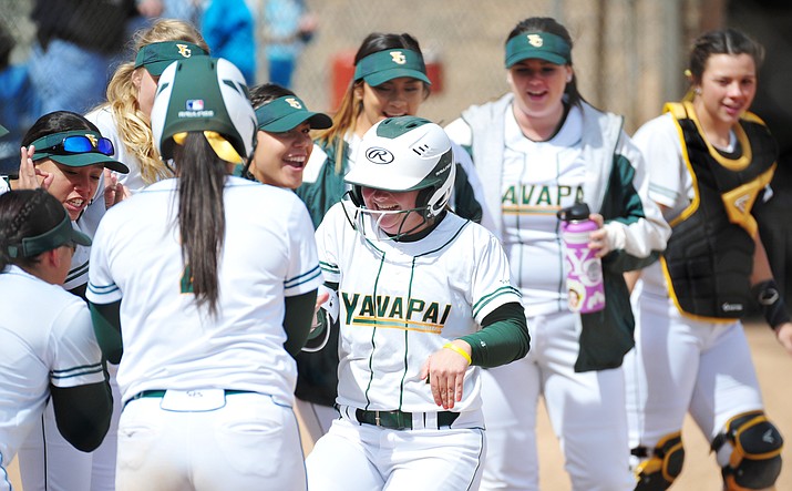 Yavapai’s Brianna Griffiths gets greeted by her teammates after a solo homer as the Roughriders hosted Scottsdale Community College on Tuesday, March 6, 2018, in Prescott. (Les Stukenberg/Courier)