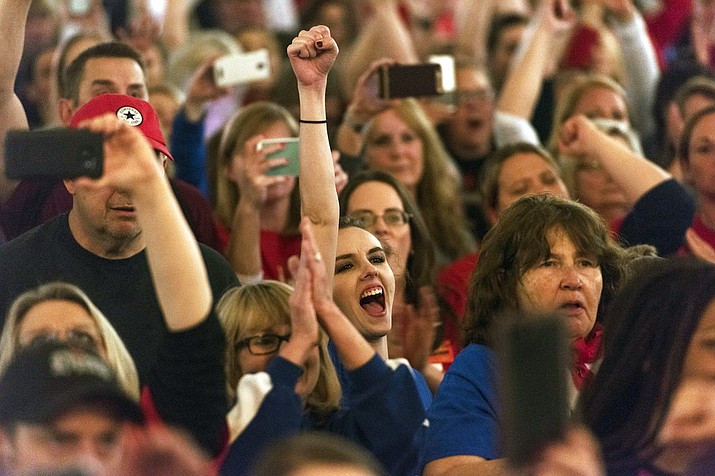 Teachers and school personnel celebrate after the state Senate approved a bill to increase state employee pay by 5 percent at the capitol in Charleston, W.Va., on Tuesday, March 6, 2018. The lawmakers unanimously approved the pay raises for teachers and troopers, after the governor reached a deal to end a teacher walkout that shuttered the state's schools for nine days. (Craig Hudson/Charleston Gazette-Mail via AP)