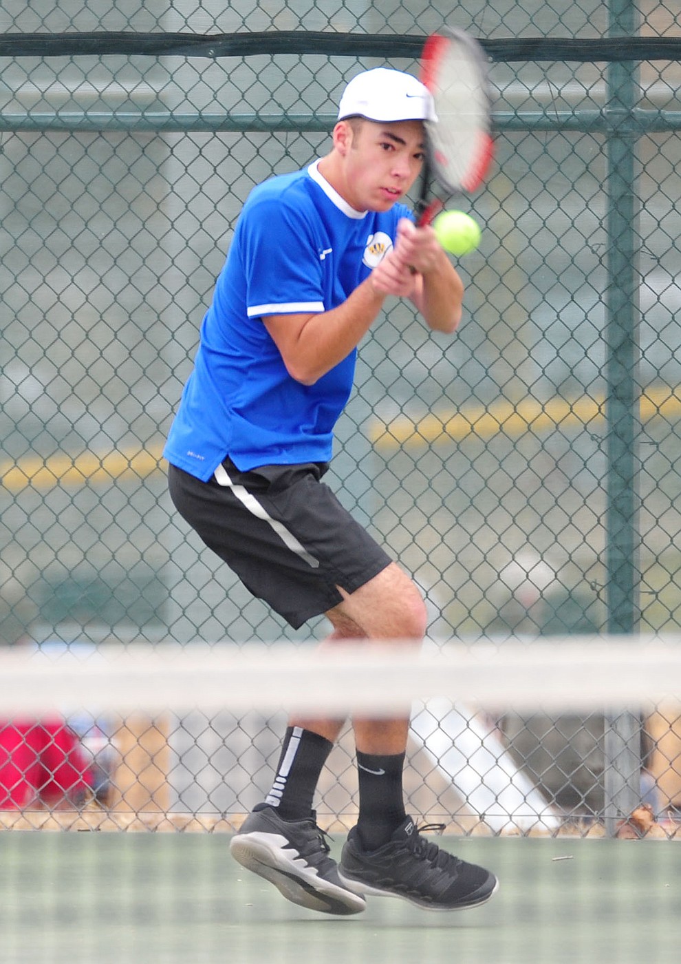Prescott's Sam Stoecker hits a return shot as the Badgers take on the Mingus Union Marauders in tennis Wednesday in Prescott. (Les Stukenberg/Courier)