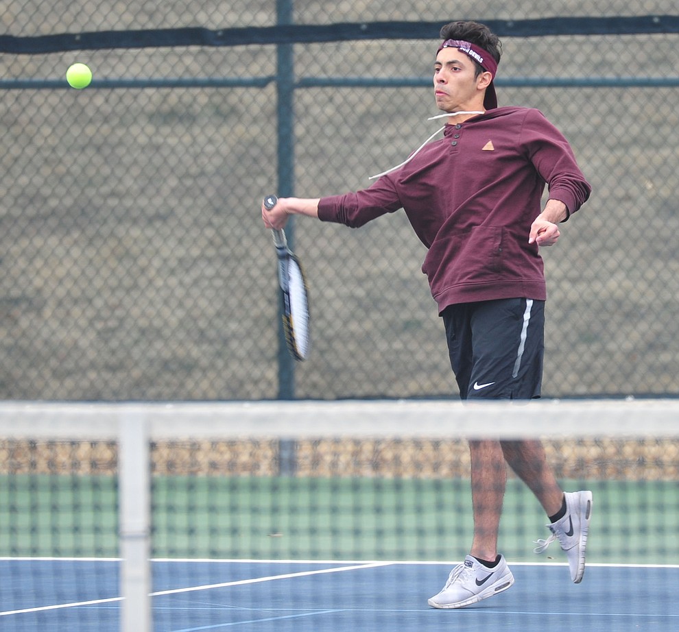 Prescott's Julio Ortega hits a return shot as the Badgers take on the Mingus Union Marauders in tennis Wednesday in Prescott. (Les Stukenberg/Courier)