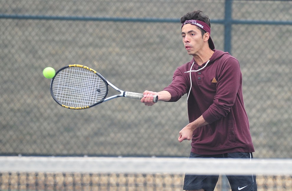 Prescott's Julio Ortega hits a return shot as the Badgers take on the Mingus Union Marauders in tennis Wednesday in Prescott. (Les Stukenberg/Courier)