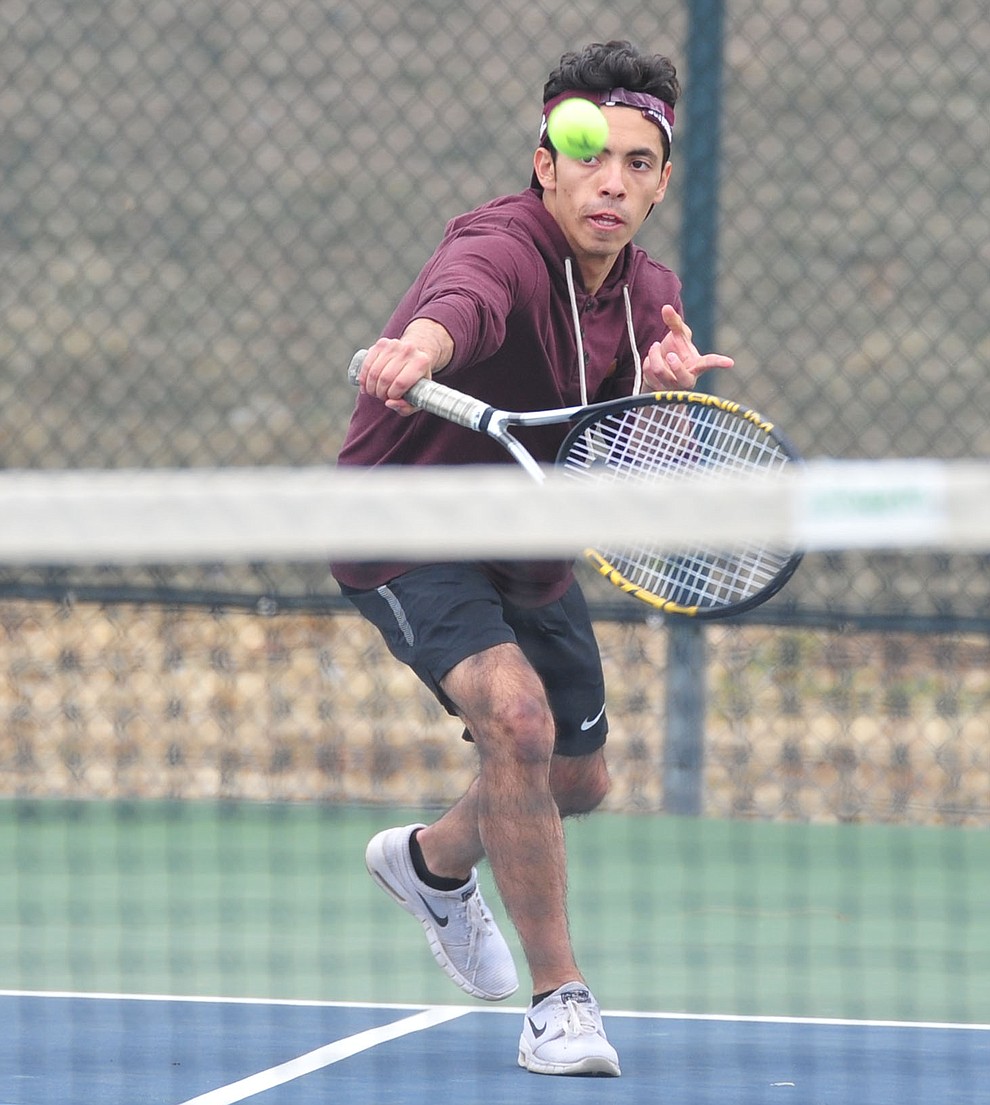 Prescott's Julio Ortega hits a return shot as the Badgers take on the Mingus Union Marauders in tennis Wednesday in Prescott. (Les Stukenberg/Courier)