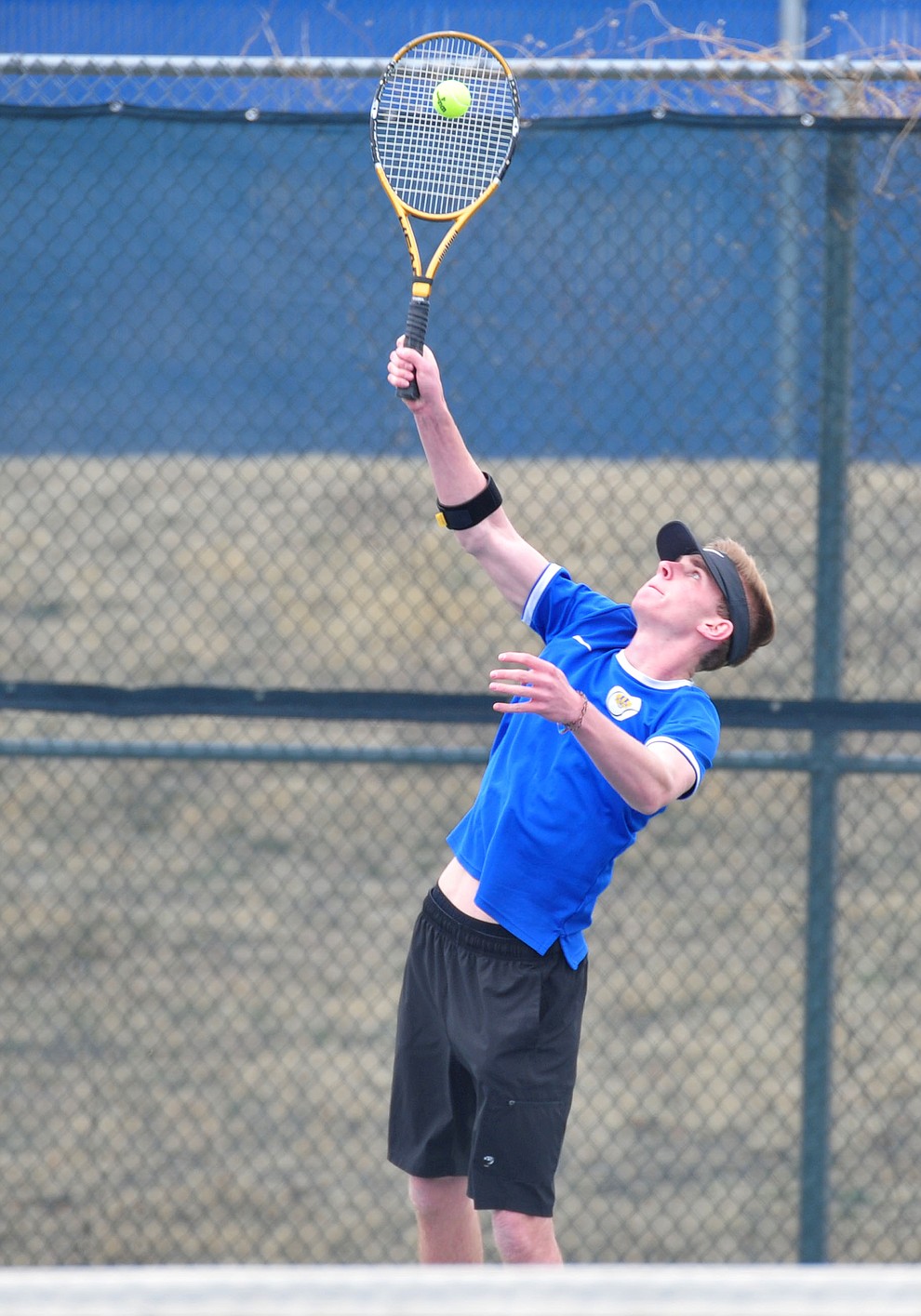 Prescott's Cutter Todd serves as the Badgers take on the Mingus Union Marauders in tennis Wednesday in Prescott. (Les Stukenberg/Courier)