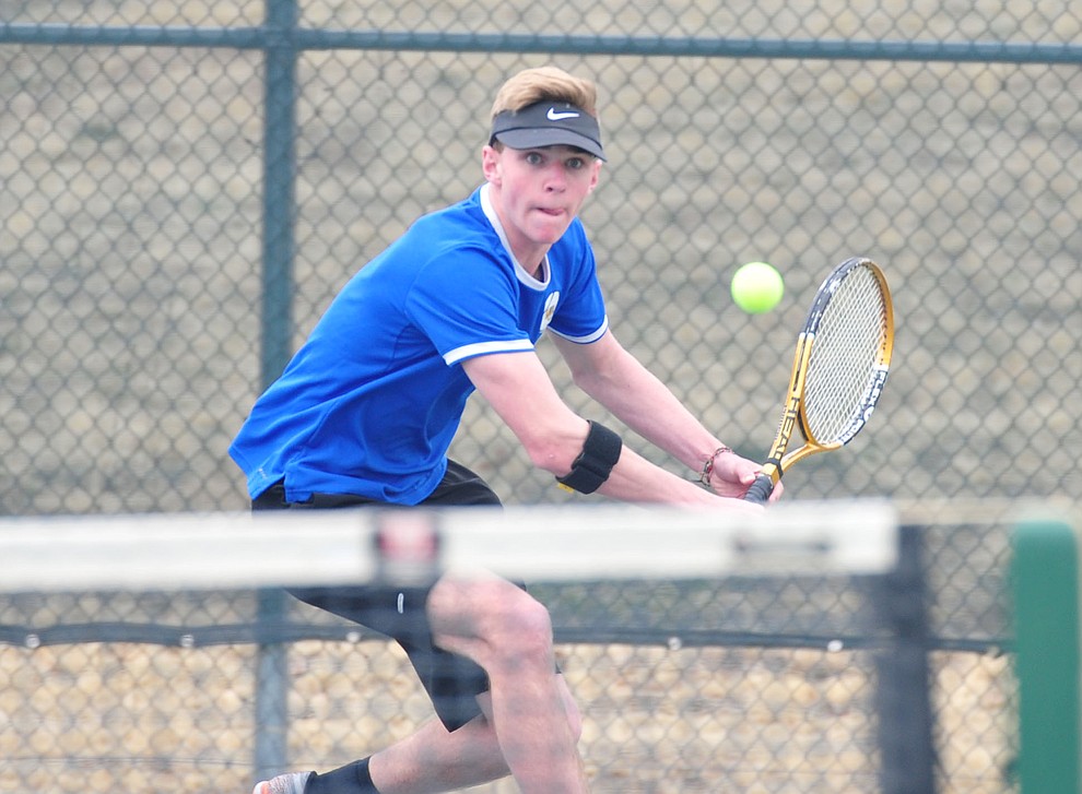 Prescott's Cutter Todd goes low for a return shot as the Badgers take on the Mingus Union Marauders in tennis Wednesday in Prescott. (Les Stukenberg/Courier)