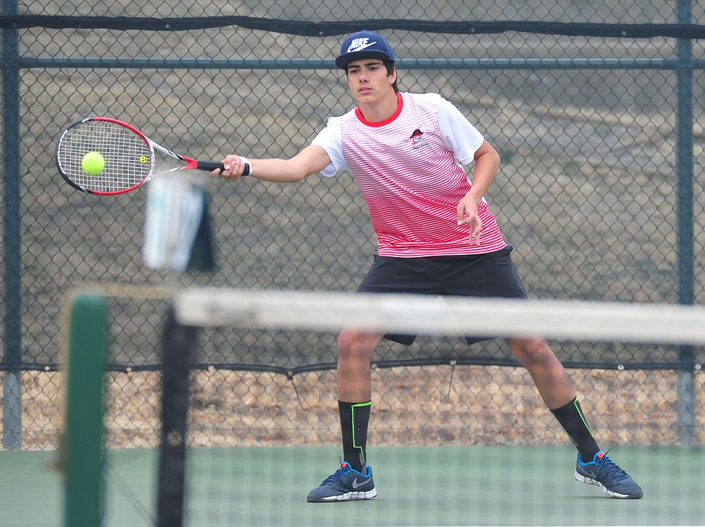 Mingus' Pedro Cremasco hits a return shot as the Marauders take on the Prescott Badgers in tennis Wednesday in Prescott. (Les Stukenberg/Courier)
