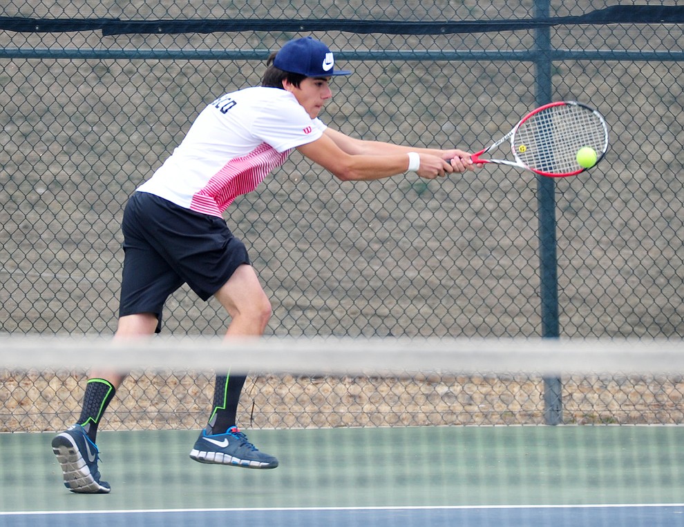 Mingus' Pedro Cremasco reaches out for a return shot as the Marauders take on the Prescott Badgers in tennis Wednesday in Prescott. (Les Stukenberg/Courier)