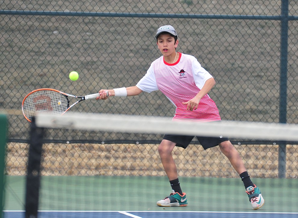 Mingus' John Valentine hits a return shot as the Marauders take on the Prescott Badgers in tennis Wednesday in Prescott. (Les Stukenberg/Courier)