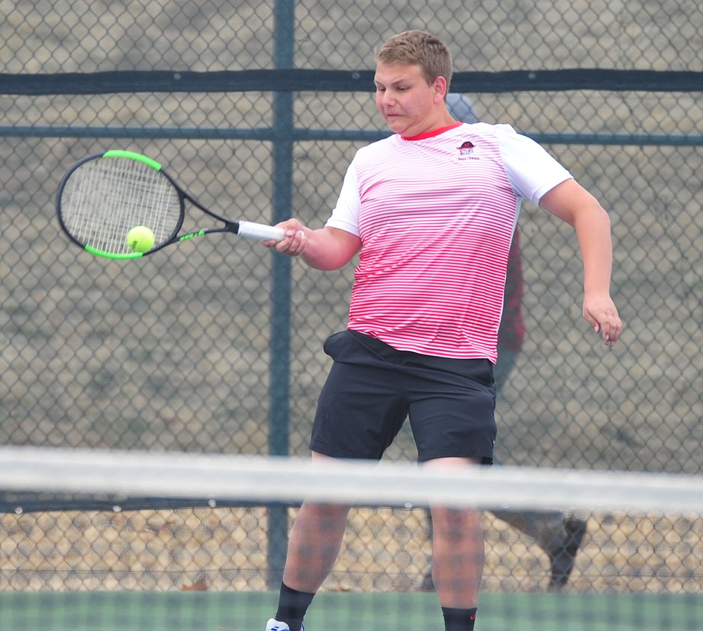 Mingus' Brigham Peterson hits a return shot as the Marauders take on the Prescott Badgers in tennis Wednesday in Prescott. (Les Stukenberg/Courier)