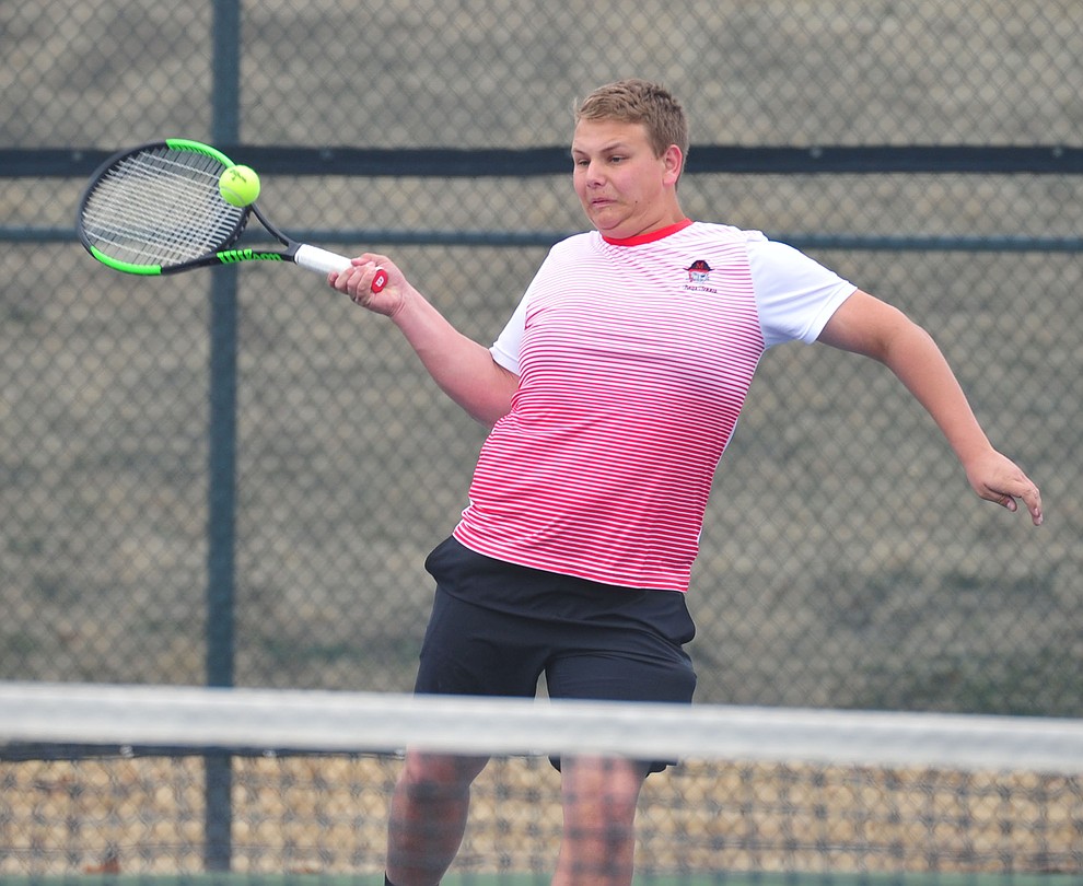 Mingus' Brigham Peterson hits a return shot as the Marauders take on the Prescott Badgers in tennis Wednesday in Prescott. (Les Stukenberg/Courier)