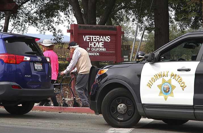 People walk to the information center at the Veterans Home of California in Yountville, Calif., on Friday March 9, 2018. A gunman took at least three people hostage at the largest veterans home in the United States on Friday, leading to a lockdown of the sprawling grounds in California, authorities said. (AP Photo/Ben Margot)