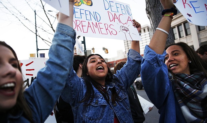 In this file photo, Bailey Evans, from left, Sayuri Madgrigal and Pauline Woods chant along Martin Luther King Boulevard during a United We Dream march in Chattanooga, Tenn., Saturday, March 3, 2018. (Doug Strickland/Chattanooga Times Free Press, via AP)