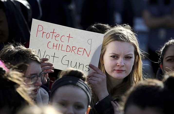 In this Feb. 28, 2018 photo, Somerville High School junior Megan Barnes marches with others during a student walkout at the school in Somerville, Mass. A large-scale, coordinated demonstration is planned for Wednesday, March 14, when organizers have called for a 17-minute school walkout nationwide to protest gun violence.