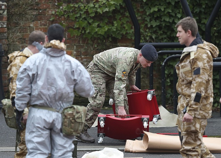 Military personnel outside Bourne Hill police station in Salisbury, England, as police and members of the armed forces probe the suspected nerve agent attack on Russian double agent spy Sergei Skripal, Sunday March 11, 2018. British government security ministers held an emergency meeting Saturday to discuss the poisoning of former spy Skripal and his daughter Yulia, as police backed by soldiers continued to search the English town where he was attacked with a nerve agent. (Andrew Matthews/PA via AP)


